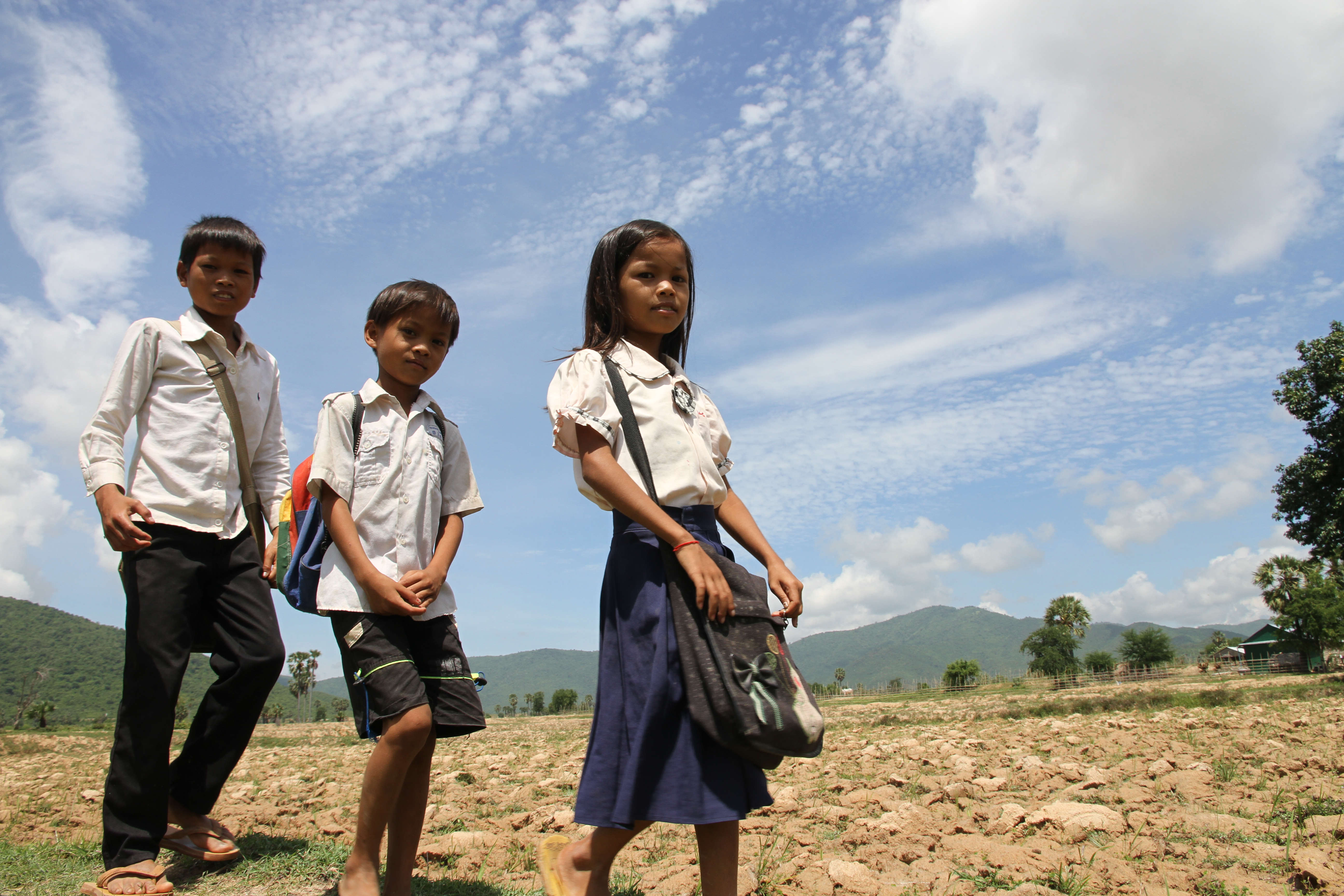 Srey Yeng, 8-year old girl, walking to school with her brothers.