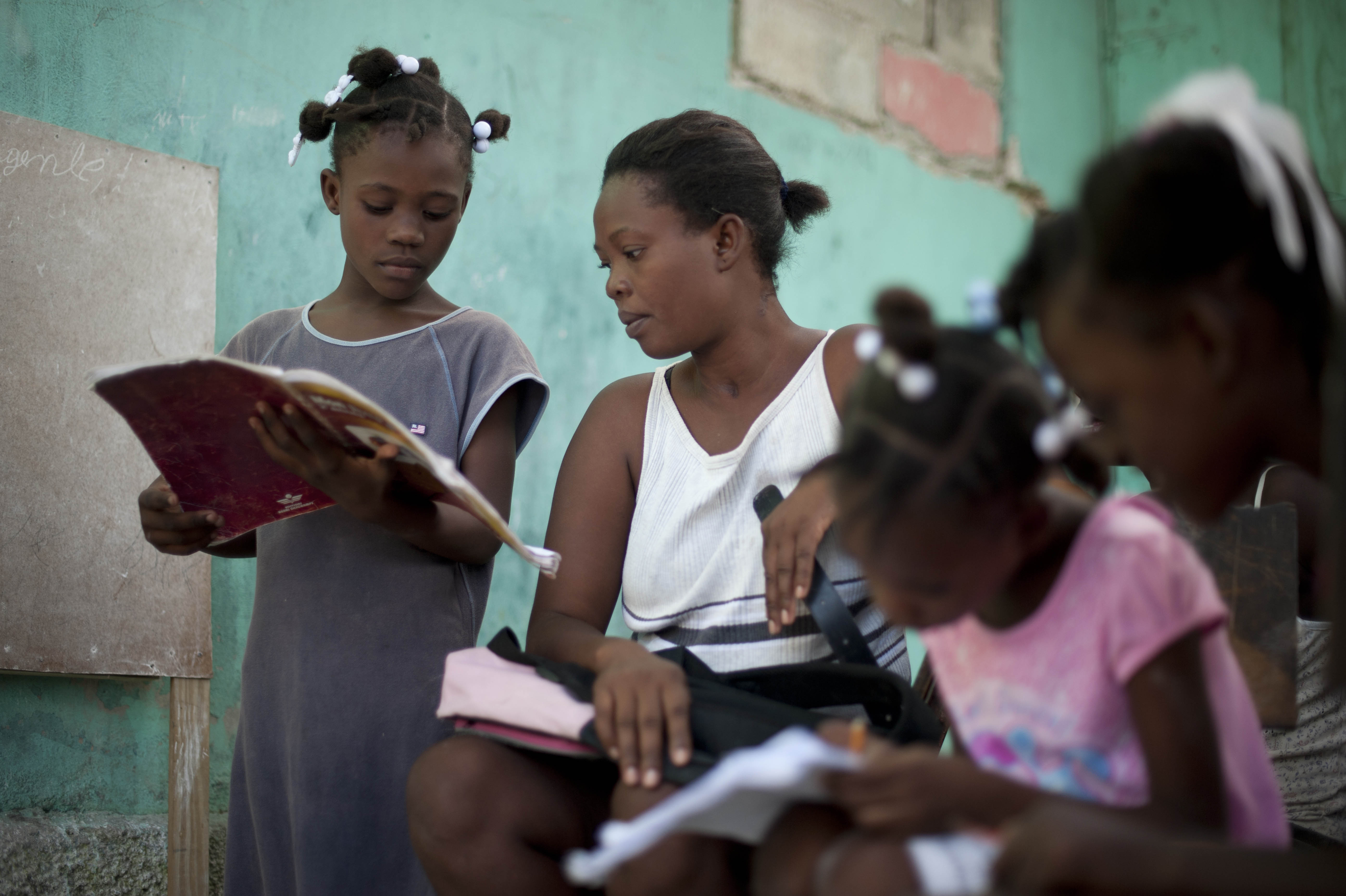 Nadege Auguste teaches her daughters at home. Access to education is a huge challenge in Haiti