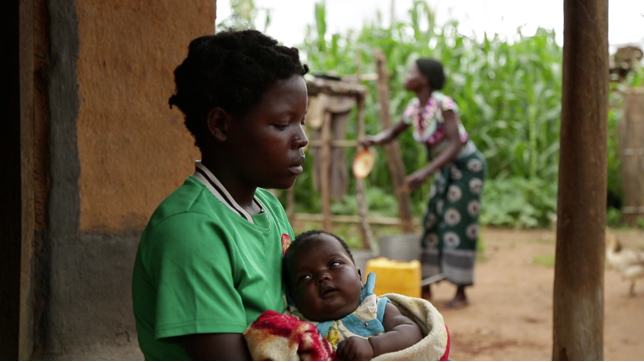 A 14-year-old girl holds her baby at her sister’s home in a village in Kanduku, in Malawi’s Mwanza district. She married in September 2013, but her husband chased her away. Her 15-year-old sister, in the background, married when she was 12. Both sisters s